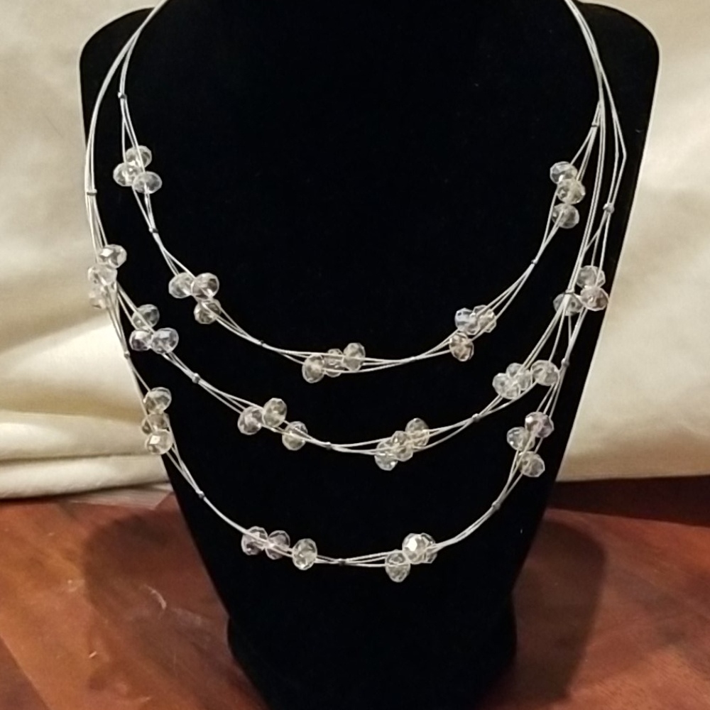 3 strand necklace with clear beads.